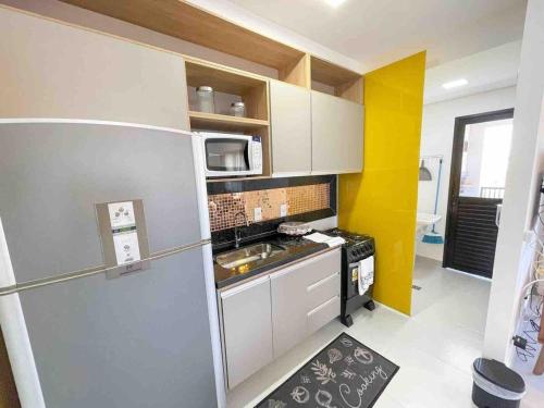 a small kitchen with a sink and a refrigerator at Condomínio Residencial Unique Residence - São José do Rio Preto in Sao Jose do Rio Preto