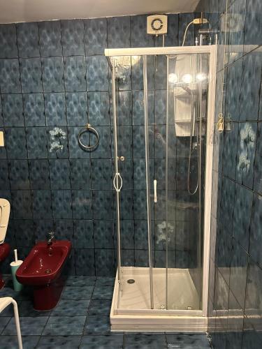 a bathroom with a shower and a red sink at Casa Coxina in Vicenza