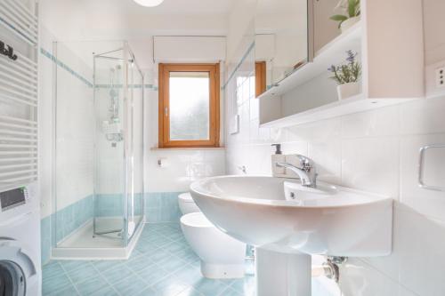 a white bathroom with a sink and a toilet at AbruzzodAmare Amazing Apartments with Romantic Sea View in Francavilla al Mare