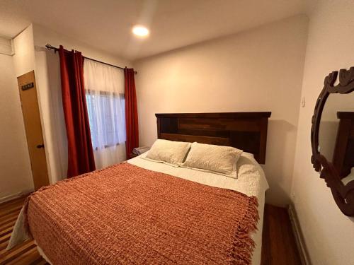 a bedroom with a bed and a red curtain at Casa Di Patti B & B in Santiago
