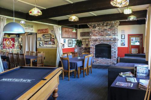 a restaurant with a pool table and a fireplace at Formerly the Blackball Hilton in Blackball