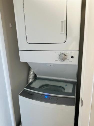 a microwave sitting on top of a washer and dryer at Condo at Happy Hour Tybee in Tybee Island