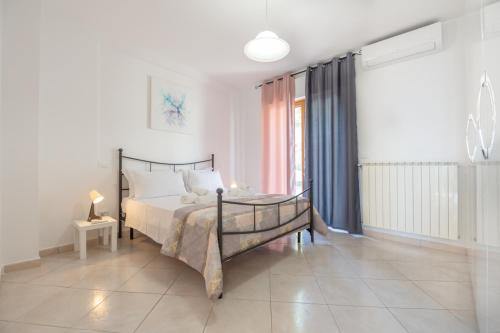 a bedroom with a bed and a large window at AbruzzodAmare Amazing Apartments with Romantic Sea View in Francavilla al Mare