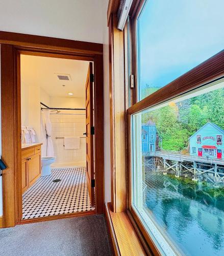 a bathroom with a view of the water through a window at Inn At Creek Street in Ketchikan