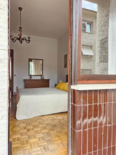 a bedroom with a bed and a mirror at La Casa di Nonna Gina in Alba