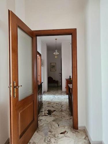 an open door to a room with a cracked floor at La Casa di Nonna Gina in Alba