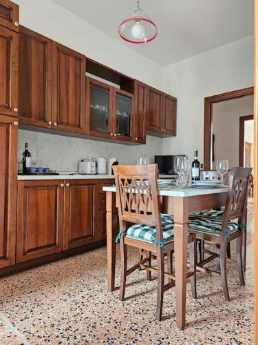 a kitchen with a table and two chairs and a counter at La Casa di Nonna Gina in Alba