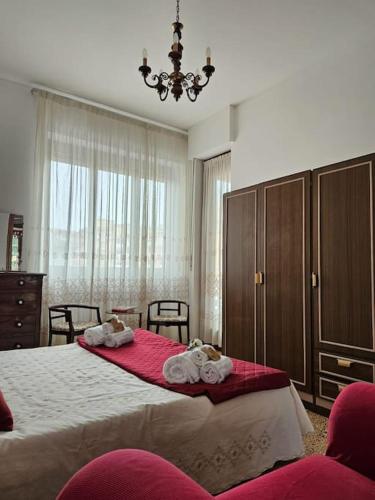 a bedroom with a large bed with towels on it at La Casa di Nonna Gina in Alba