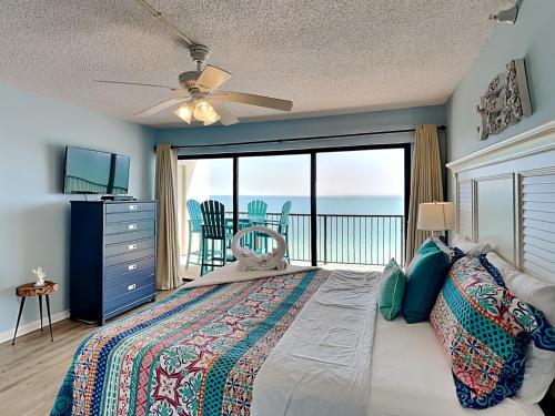 a bedroom with a bed with a view of the ocean at Ocean Sands 1002 in St. Pete Beach