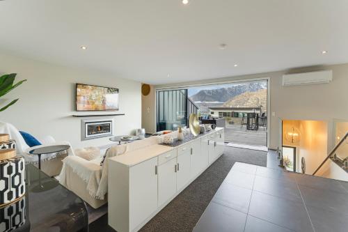 a living room with a couch and a table at Queenstown Lake and Mountain View Retreat Free Wifi Free Street Parking in Queenstown