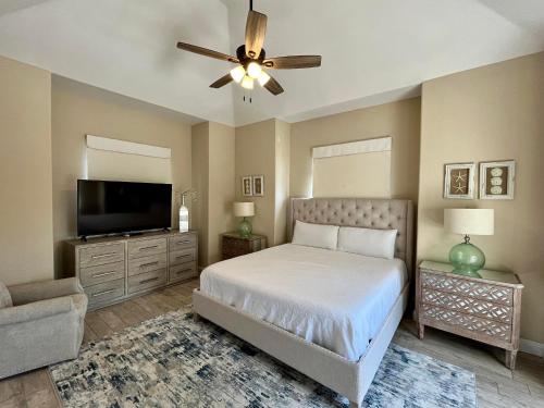 a bedroom with a bed and a flat screen tv at Seaside Hideaway in Destin