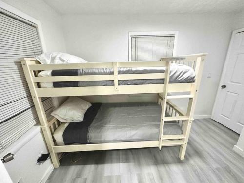 a couple of bunk beds in a room at Modern cozy with pool and big backyard in Tampa