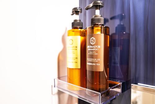 two bottles ofodorizers are sitting on a shelf at アナザースカイ京都二条城 in Kinugasa