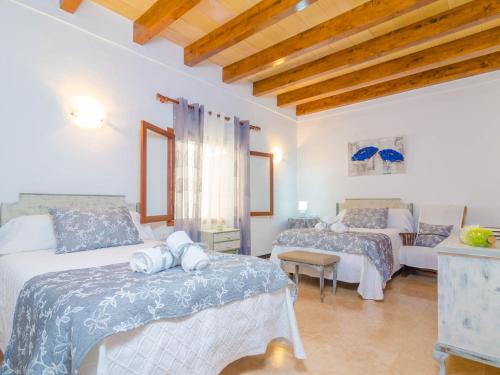 a bedroom with two beds and a couch at Can Pedro Ros - House In S'illot-cala Morlanda Free Wifi in S'Illot
