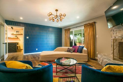 a living room with a couch and a table at Oasis Retreat - Hot Tub - King Bd - Fire Pit - Games - Near Golf - 4 Bdrm - Sleeps up to 12 in Albuquerque