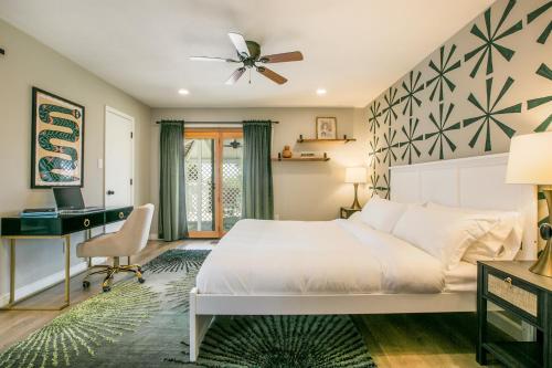 a bedroom with a bed and a desk at Oasis Retreat - Hot Tub - King Bd - Fire Pit - Games - Near Golf - 4 Bdrm - Sleeps up to 12 in Albuquerque