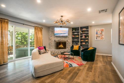 a living room with a couch and chairs and a fireplace at Oasis Retreat - Hot Tub - King Bd - Fire Pit - Games - Near Golf - 4 Bdrm - Sleeps up to 12 in Albuquerque