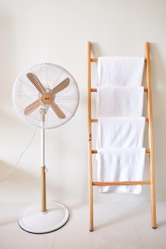 a fan sitting next to a towel rack and a towel rackyss at QFandZ Baguio Homestay at BRENTHILL Condominium in Baguio