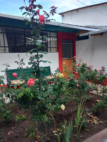 a house with a bench and flowers in front of it at Hospedaje Casa Primavera in Cotahuasi