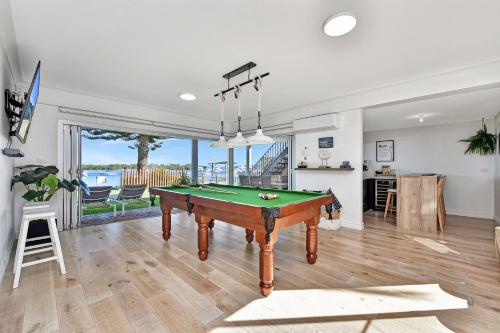 a living room with a pool table in it at Reflections at Sunset Beach in Soldiers Point