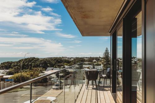 a balcony with a view of the ocean at The Coomber - Apartments & Studios in New Plymouth