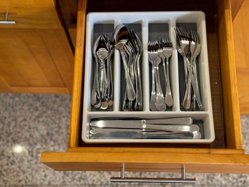 a drawer filled with utensils in a cabinet at # Marbella Lane - Vibrant 5BR Home in Daly City in Daly City