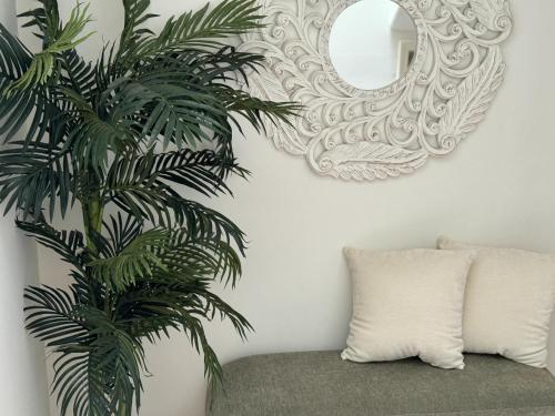 a mirror hanging on a wall next to a couch at # Marbella Lane - Vibrant 5BR Home in Daly City in Daly City