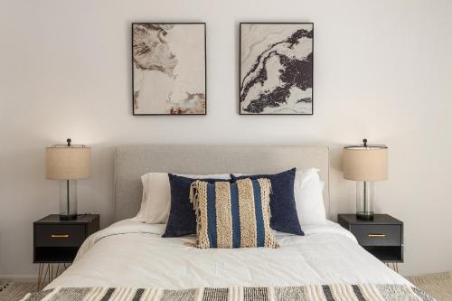 a bedroom with a white bed with two night stands at # Marbella Lane - Vibrant 5BR Home in Daly City in Daly City