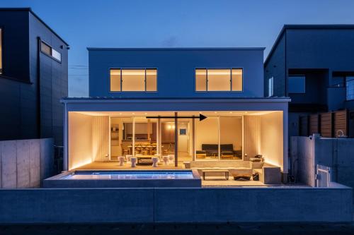 a house with a view of the backyard at SETO CLAS TSUDA THE BEACH RESORT C in Yoshimi