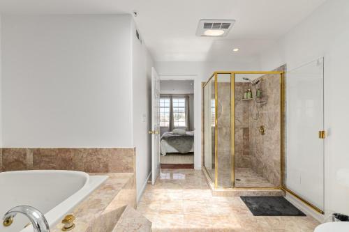 a bathroom with a tub and a shower at # Marbella Lane - Vibrant 5BR Home in Daly City in Daly City