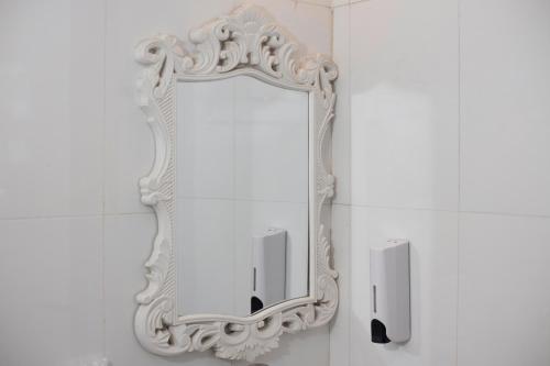 a white mirror on a wall in a bathroom at Central Sapa Serenity Homestay in Sa Pa