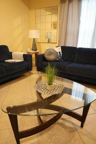 a living room with a couch and a glass table at Mirror, mirror on the wall! in McAllen