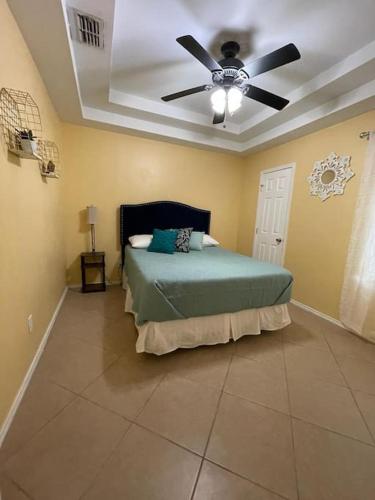 a bedroom with a bed and a ceiling fan at Mirror, mirror on the wall! in McAllen