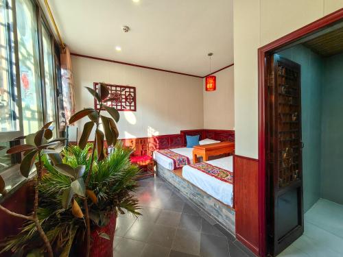 a room with a bed and a couch in it at Pingyao Harmony Hotel in Pingyao