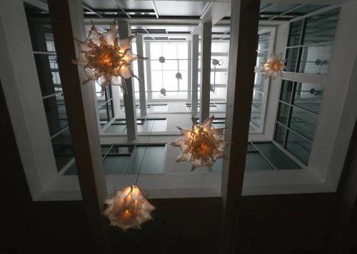 a reflection of a room with lights in a mirror at Stanton House El Paso in El Paso