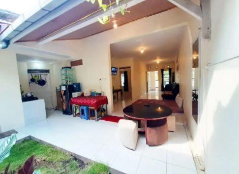 a living room with a table and a couch at OKJ Homestay Syariah in Gondowulung