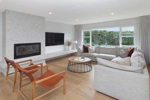 a living room with a couch and a table at Carterley House in Christchurch