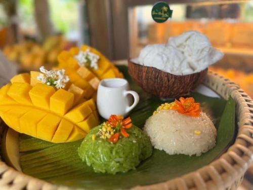 a plate of food with rice and a cup of coffee at Greenheart garden View Camp phuket in Kata Beach