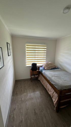 Una cama o camas en una habitación de CASA EN CONDOMINIO LOS NOTROS ( PUCON )