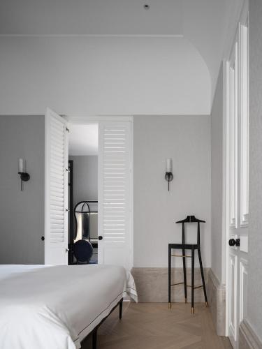 a bedroom with a white bed and a desk at Opartment - People's Square 远东饭店 - 人民广场 in Shanghai