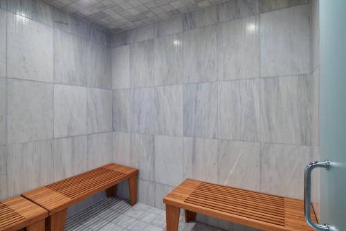 a room with two wooden benches and a wall at Stanton House El Paso in El Paso
