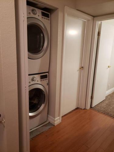 a laundry room with two washer and dryer at Centrally located to Strip, UNLV, Stadiums and so much more! in Las Vegas