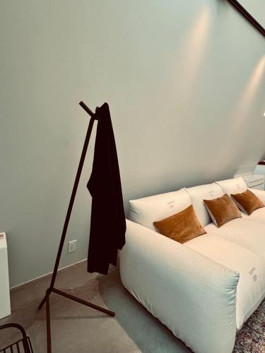 a bedroom with a white bed and a lamp at TRIGON HOUSE HOTEL KOFU in Kofu
