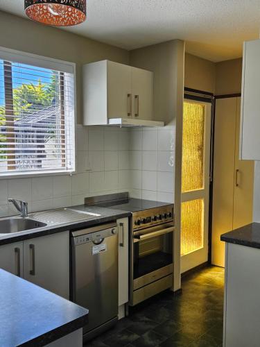 a kitchen with a sink and a stove top oven at 27 Alpine Avenue in Hanmer Springs