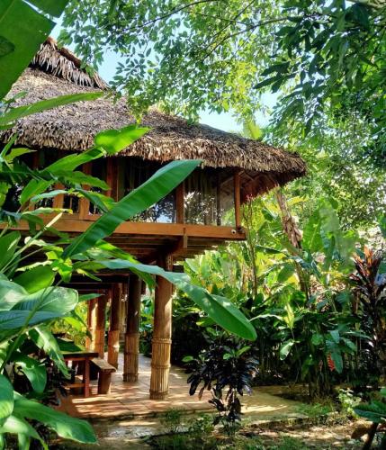 a bamboo hut with a thatched roof at PU LUONG BOUTIQUE GARDEN in Pu Luong