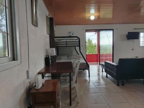 a living room with a bunk bed and a couch at Hotel Cabañas Casita La Ermita in San Carlos