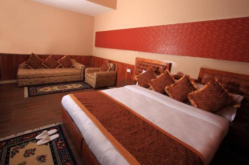 a hotel room with a bed and a couch at Yarlam Portico in Gangtok