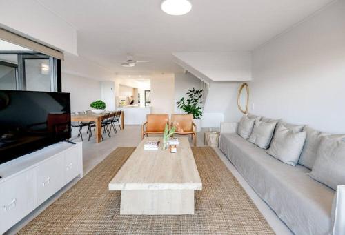 a living room with a couch and a tv at Pooch Friendly Renovated Beach Retreat with Views in Sunrise Beach