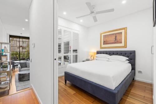 a bedroom with a bed and a living room at 1-Bed Unit with Alfresco Dining and BBQ in Sydney