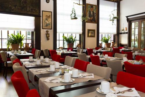 a dining room with tables and red chairs at Best Western Plus Monopole Métropole in Strasbourg